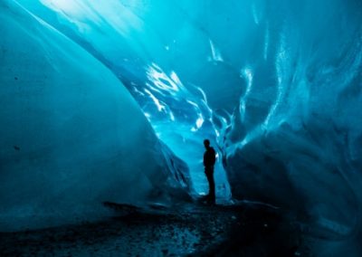 A student standing in an ice cave