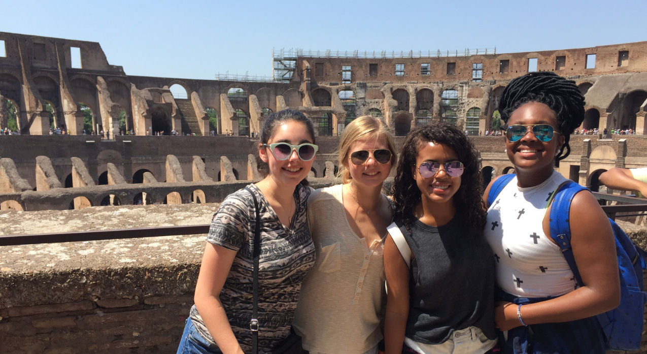 Group of students posing in front of the Colosseum in Rome, Italy