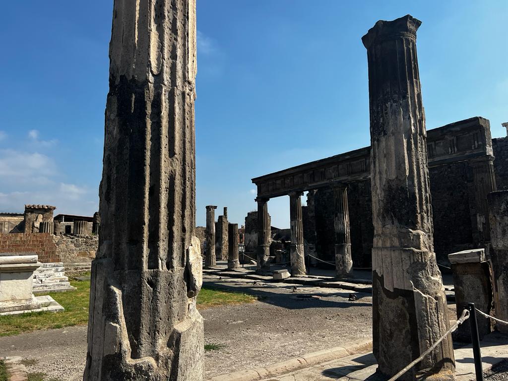 Large old columns in front of blue sky.