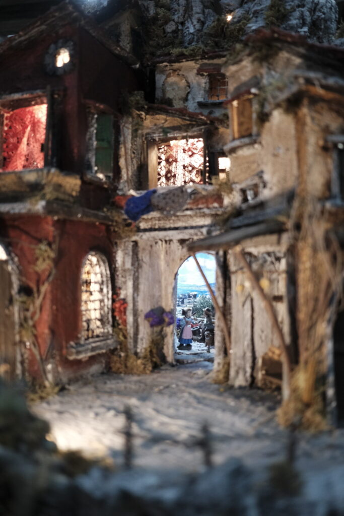 Close up of figurines in a diorama of old streets.