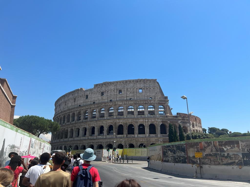 View of the Colosseum against blue sky.