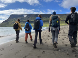 students hiking on beach