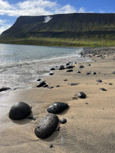 rocks on sand at shoreline