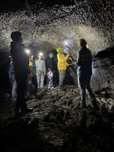 Students wearing hard hats in cave.